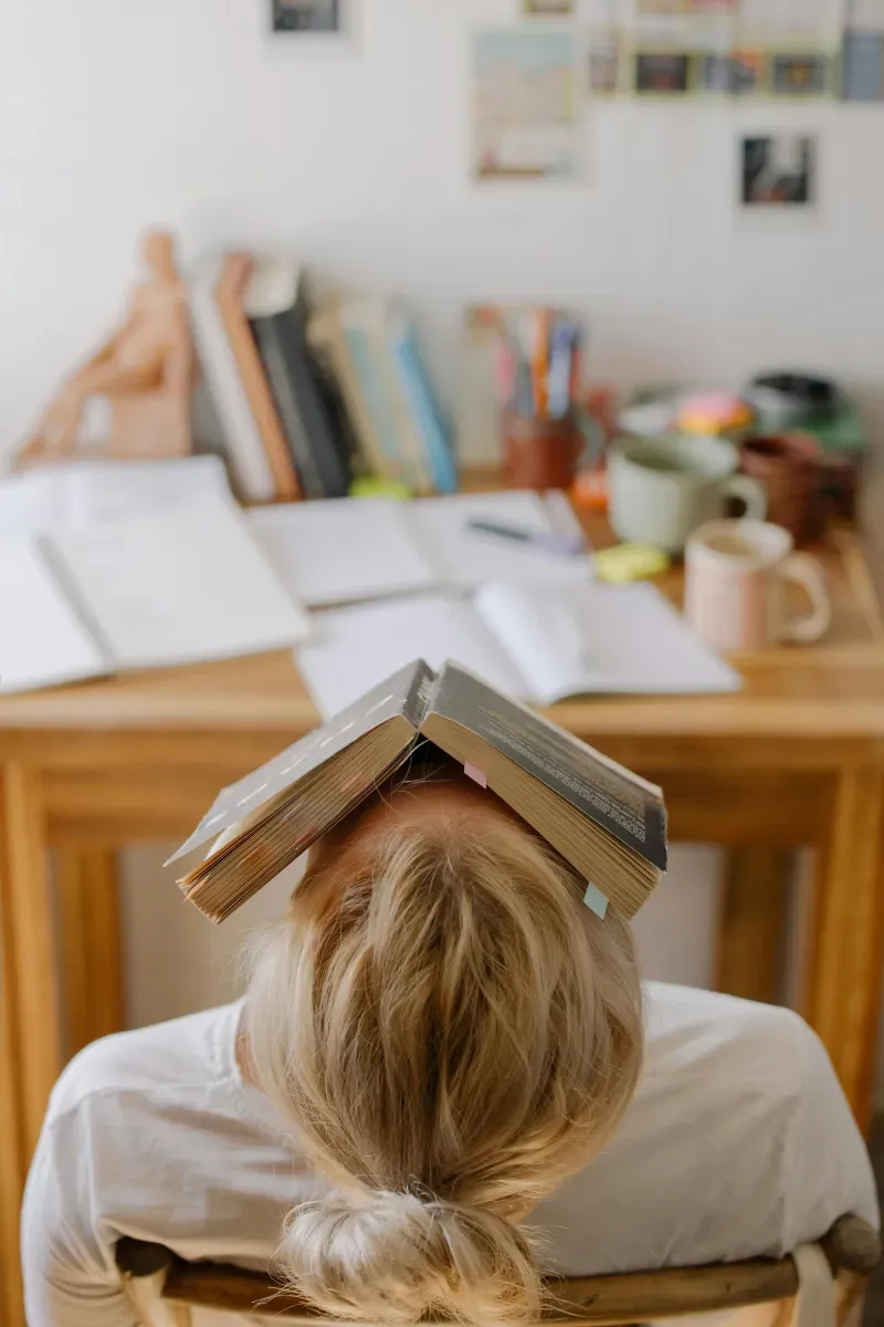 Stressed woman with a book on her face