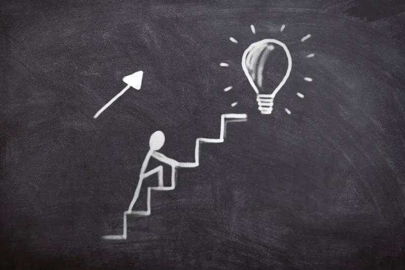 Person climbing stairs, representing achieved goals
